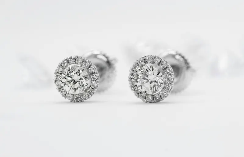 Pair of round diamond halo stud earrings on white, a common 5mm earrings actual size reference