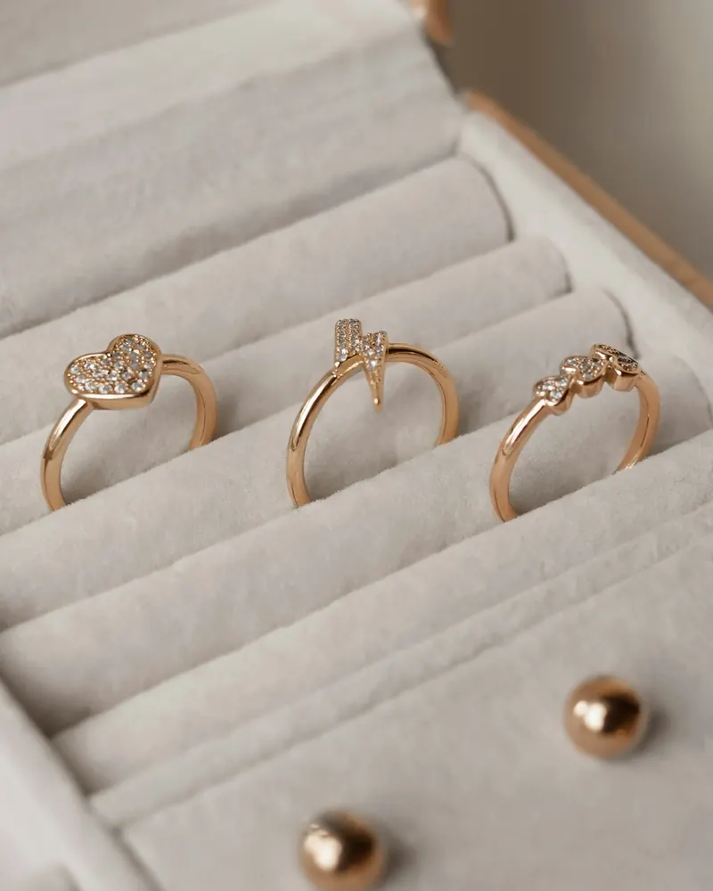 Jewelry box with rings and small gold ball stud earrings, a simple earring holder idea